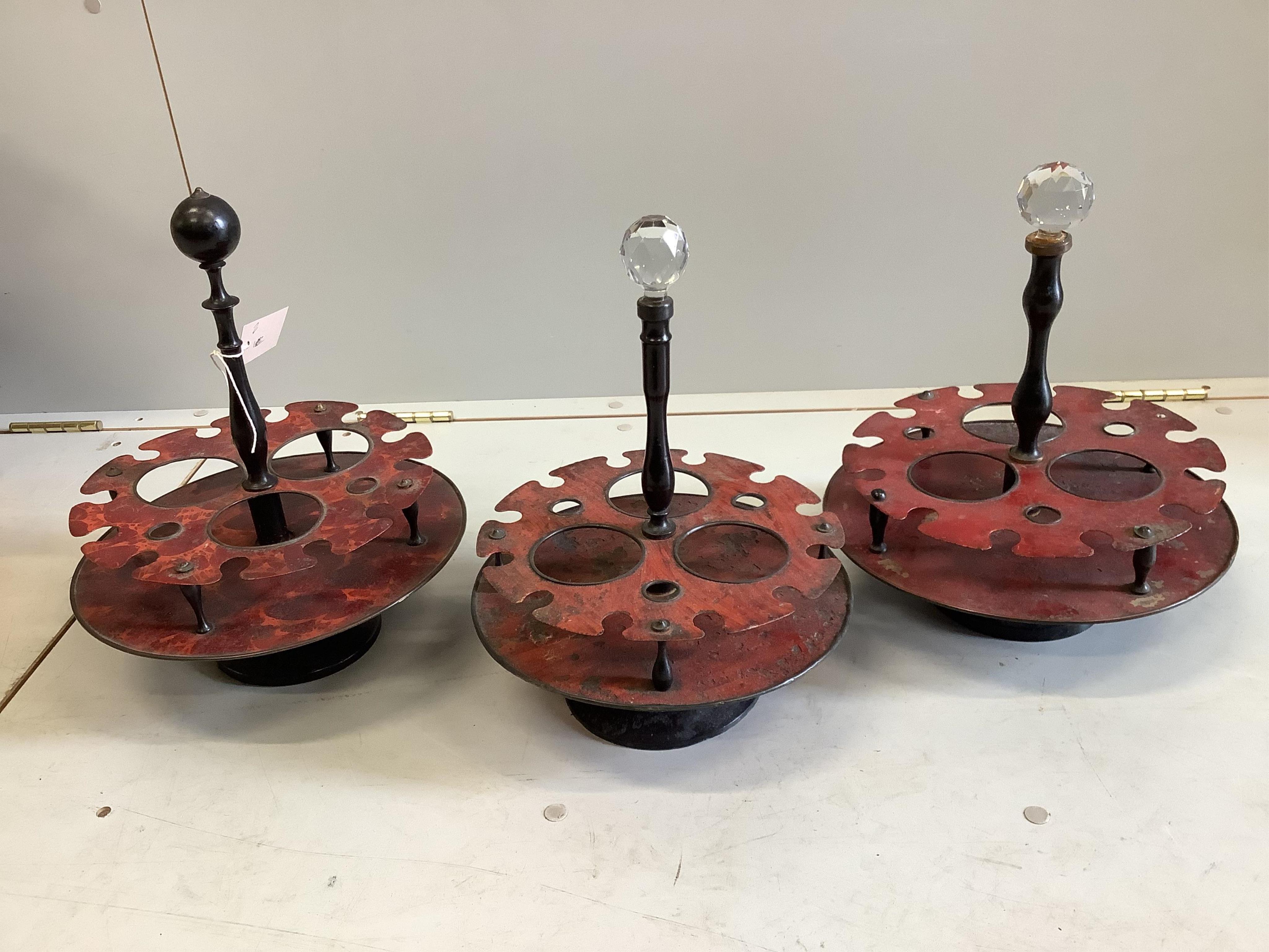 Three early 20th century French toleware and turned beech liqueur stands, diameter 13cm. Condition - fair